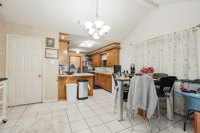 kitchen featuring visible vents, brown cabinets, a notable chandelier, a peninsula, and vaulted ceiling with beams