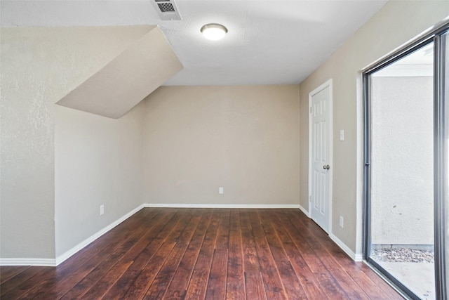 bonus room featuring visible vents, baseboards, and hardwood / wood-style floors