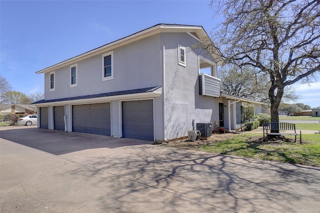 view of home's exterior featuring a garage, stucco siding, and concrete driveway