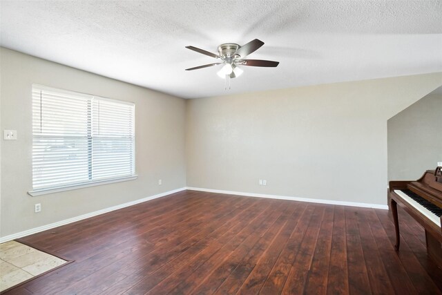 interior space with baseboards, a ceiling fan, hardwood / wood-style flooring, and a textured ceiling
