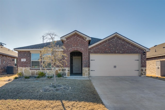 ranch-style home with brick siding, cooling unit, a garage, stone siding, and driveway