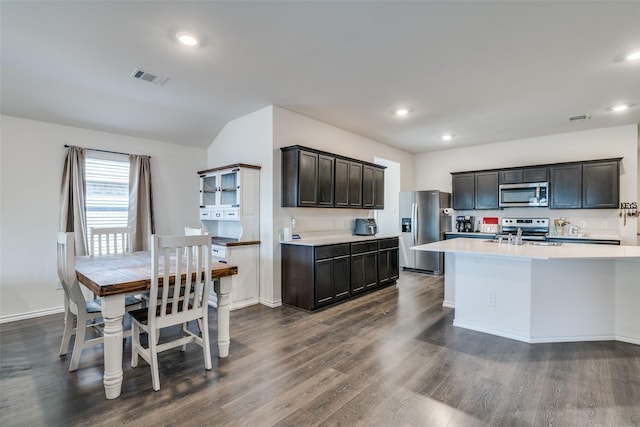 kitchen featuring dark wood finished floors, visible vents, stainless steel appliances, and light countertops