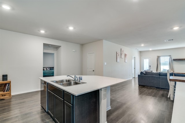 kitchen featuring a sink, visible vents, dishwasher, and dark wood-style flooring