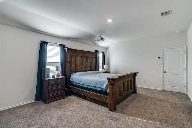 carpeted bedroom featuring visible vents and baseboards