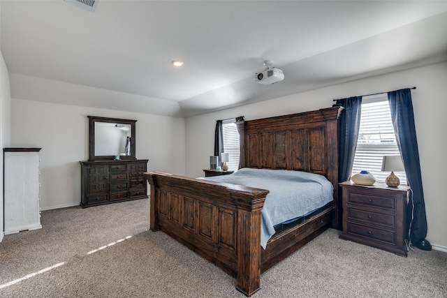 bedroom with multiple windows, light colored carpet, and baseboards