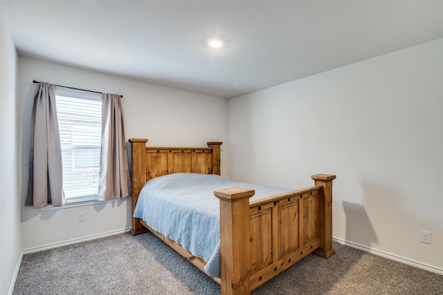 carpeted bedroom featuring baseboards