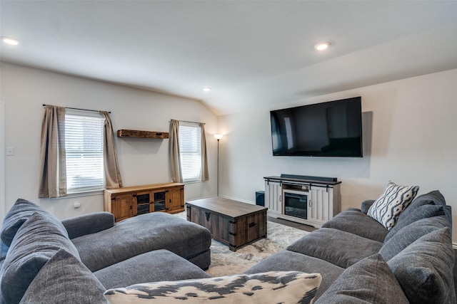 living area with lofted ceiling and recessed lighting