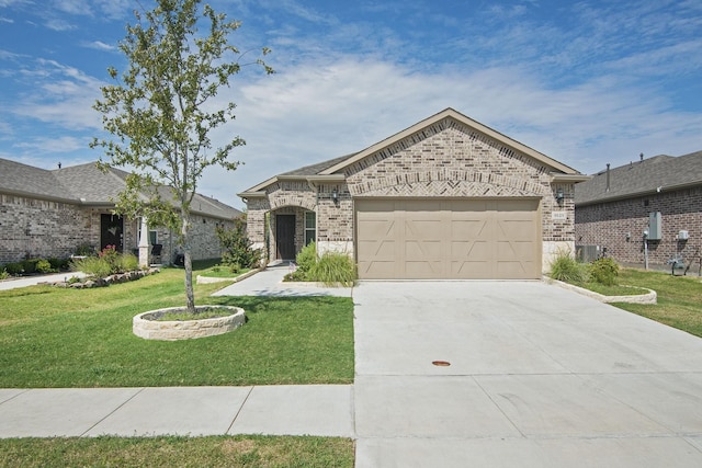 french country style house with brick siding, a front lawn, concrete driveway, central AC unit, and an attached garage