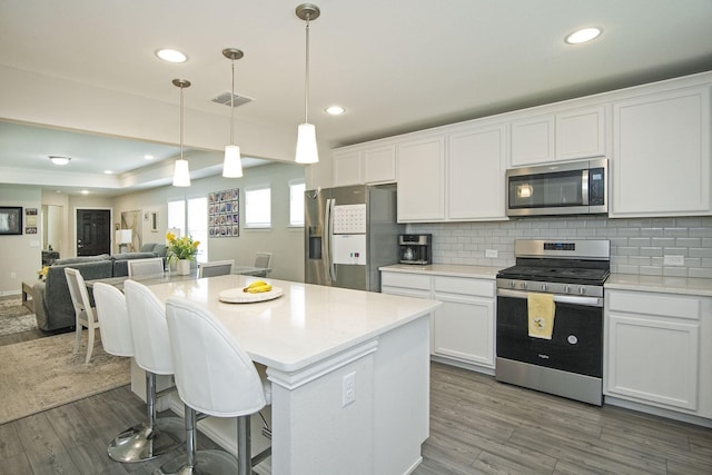 kitchen with white cabinetry, tasteful backsplash, and appliances with stainless steel finishes