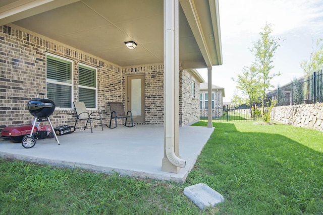 view of patio featuring a grill and fence