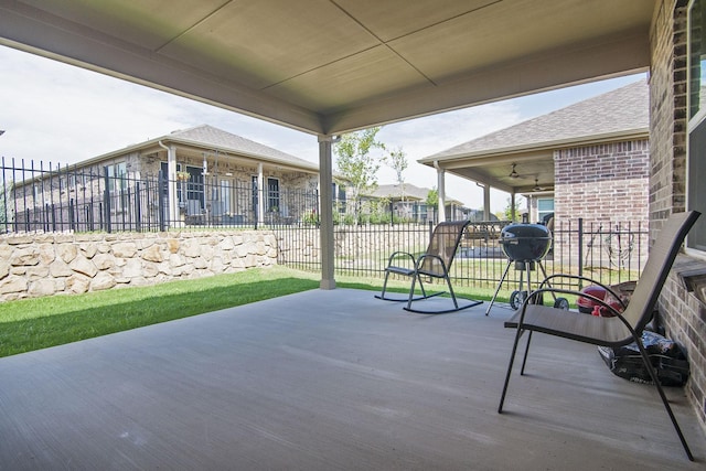 view of patio featuring ceiling fan and fence