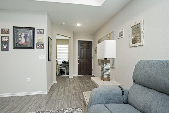 entrance foyer featuring recessed lighting, wood finished floors, and baseboards