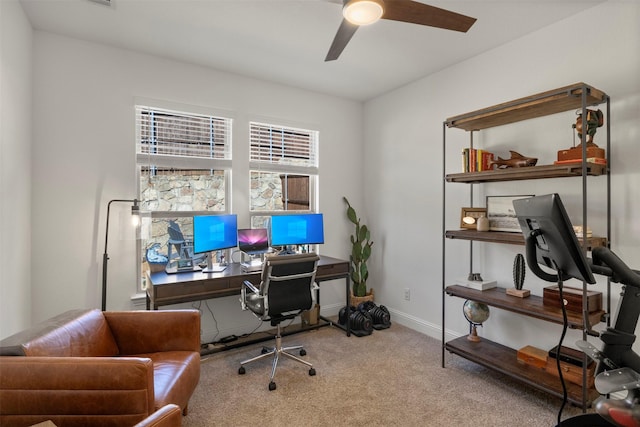 office space featuring carpet flooring, a ceiling fan, and baseboards