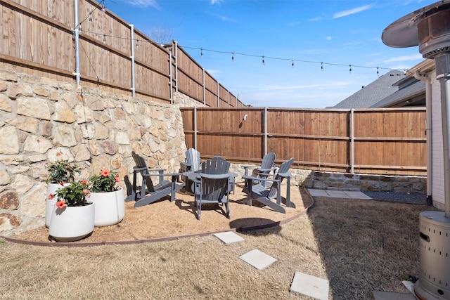 view of yard with a patio, a fire pit, and a fenced backyard