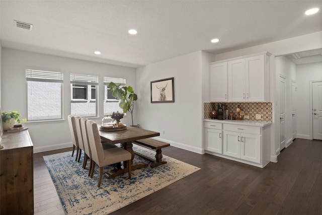 dining room with dark wood-type flooring, recessed lighting, baseboards, and visible vents