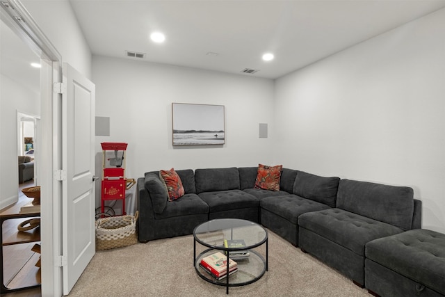 carpeted living room with visible vents and recessed lighting