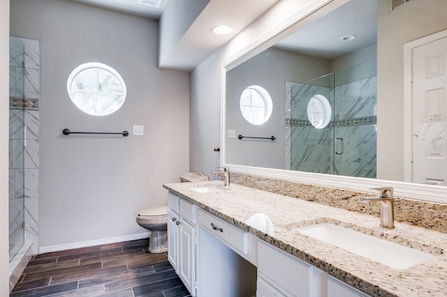 bathroom with a sink, baseboards, a stall shower, and wood tiled floor