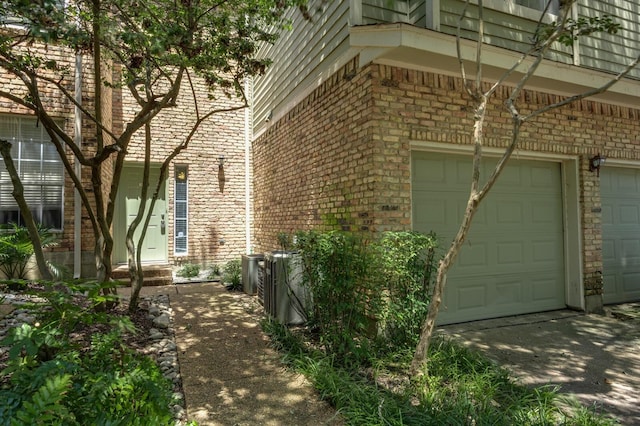 view of property exterior featuring a garage and brick siding