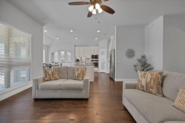 living area with visible vents, lofted ceiling, recessed lighting, ceiling fan, and dark wood-type flooring