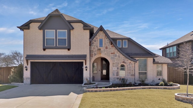 view of front of house featuring brick siding, stone siding, a front lawn, and fence