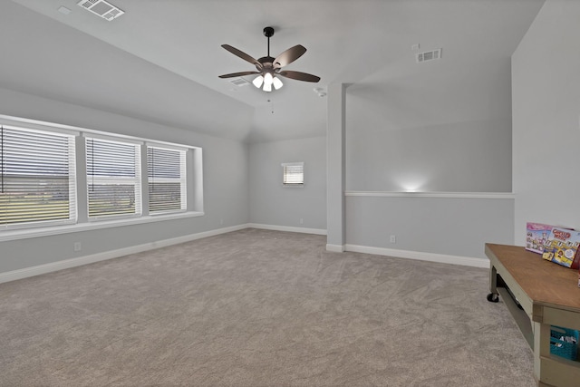 carpeted empty room with visible vents, baseboards, and a healthy amount of sunlight