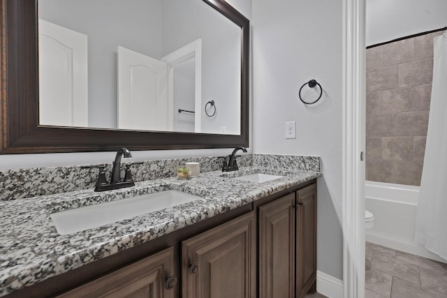 bathroom with a sink, toilet, double vanity, and shower / bath combination with curtain