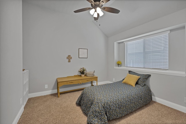 carpeted bedroom featuring baseboards, lofted ceiling, and ceiling fan