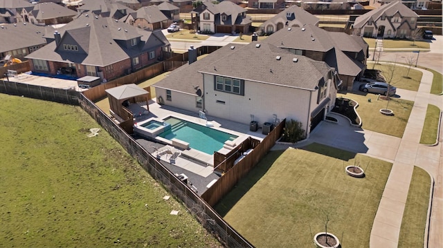 view of pool with a residential view, a lawn, a patio, and a fenced backyard