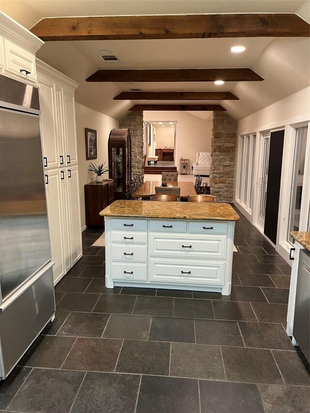 7045 Layman Dr, Eustace, TX 75124 - kitchen with stainless steel built in refrigerator, white cabinets, a center island, and light stone countertops