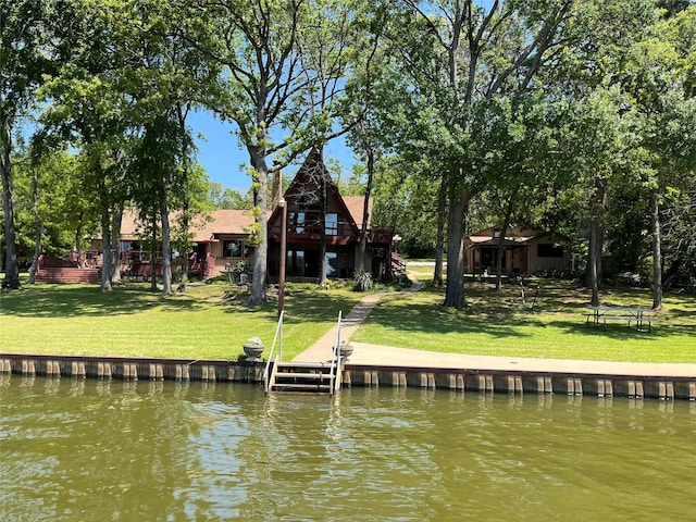 view of dock featuring a lawn and a deck with water view