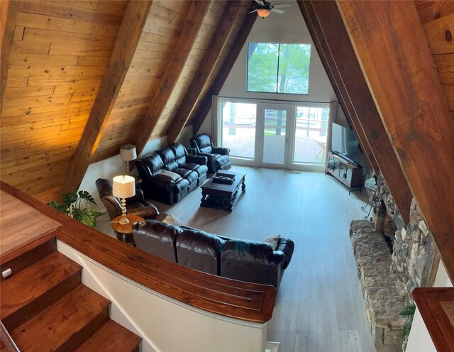 living area with wood ceiling, ceiling fan, lofted ceiling with beams, and wood finished floors