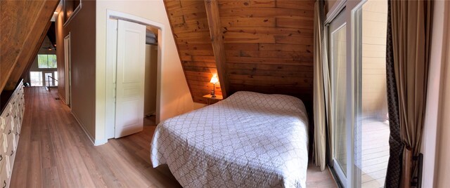 bedroom featuring baseboards and wood finished floors