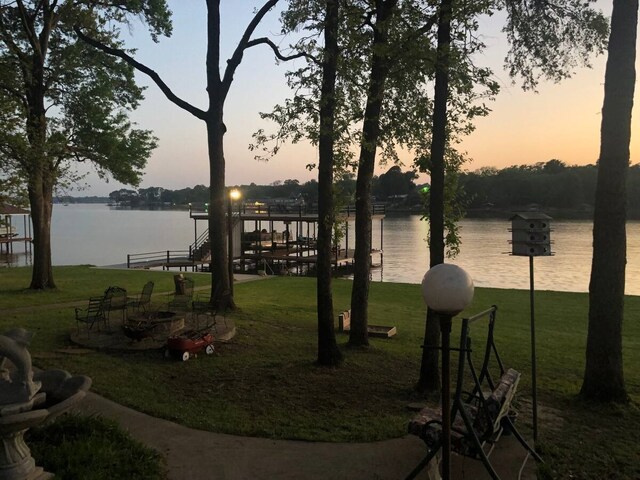 exterior space with a lawn and a water view