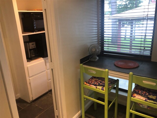 dining room with dark tile patterned floors