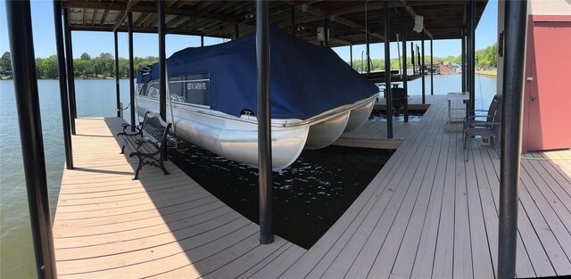view of dock featuring boat lift and a water view