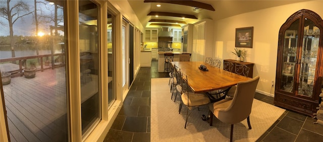 dining space featuring recessed lighting, arched walkways, and dark tile patterned flooring