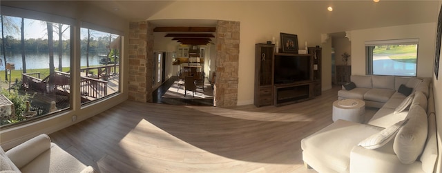 living room featuring a water view and wood finished floors
