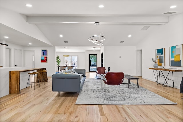 living room featuring lofted ceiling with beams, baseboards, recessed lighting, and light wood finished floors