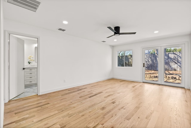 unfurnished bedroom featuring access to outside, wood finished floors, and visible vents