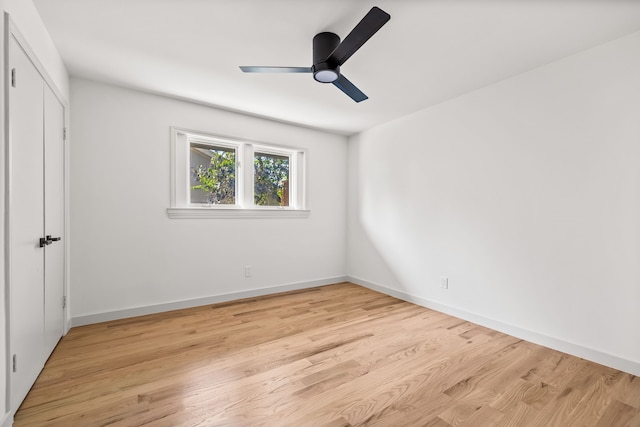 unfurnished bedroom with a closet, baseboards, light wood-style floors, and ceiling fan