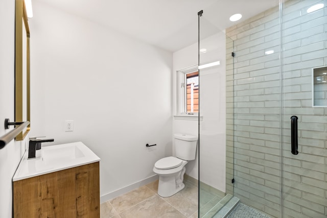 full bathroom with vanity, toilet, baseboards, and a stall shower