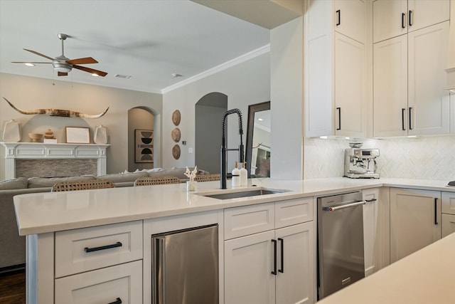 kitchen with a sink, open floor plan, and light countertops