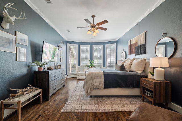 bedroom with dark wood finished floors, visible vents, crown molding, and a textured wall