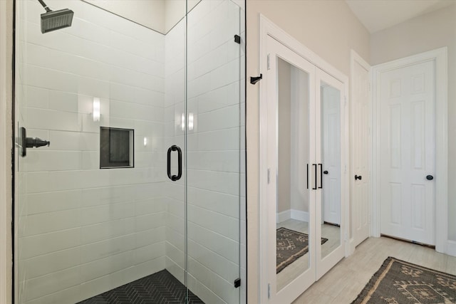 full bathroom with wood finished floors and a stall shower