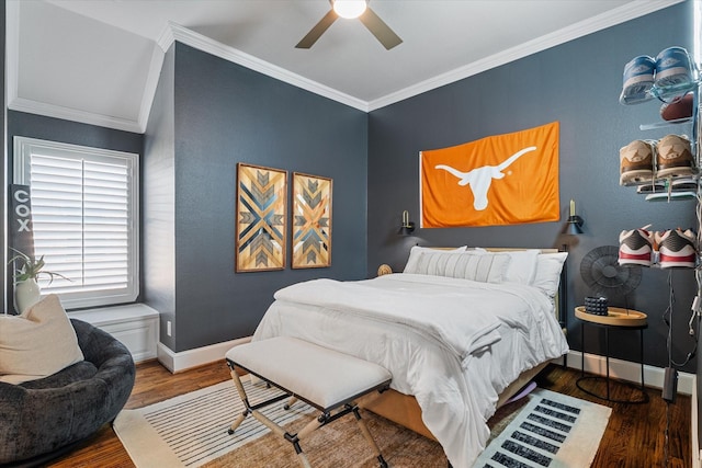 bedroom with ceiling fan, baseboards, wood finished floors, and crown molding