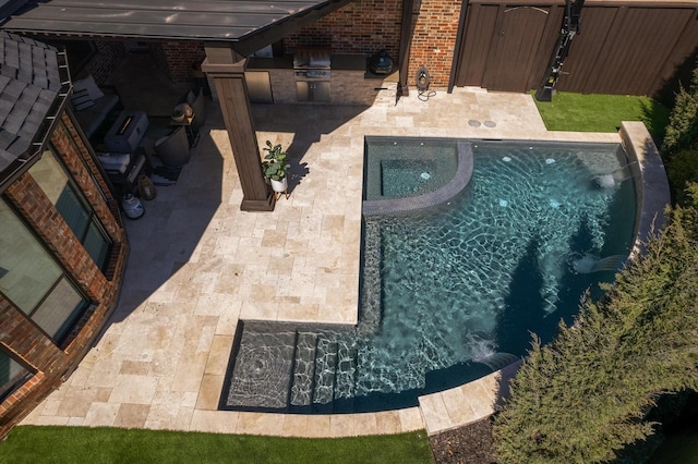 view of pool featuring area for grilling, an in ground hot tub, and a patio area