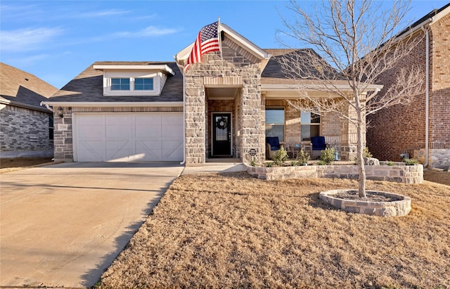 view of front of house featuring stone siding and concrete driveway