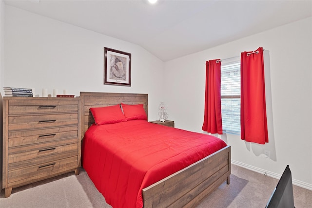 bedroom featuring vaulted ceiling, baseboards, and carpet floors