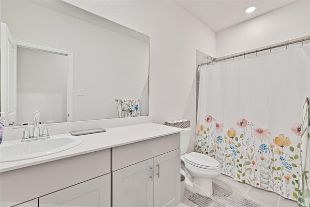 bathroom with vanity, curtained shower, toilet, and tile patterned flooring