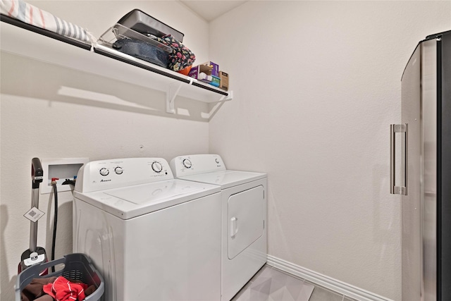 laundry area featuring washer and dryer, laundry area, and baseboards